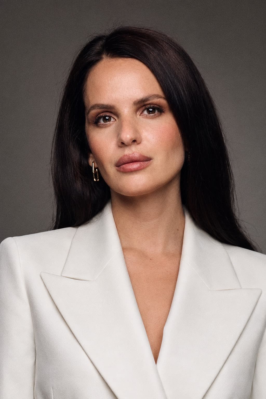 Anna Bon, entrepreneur and investor, in a cream tailored jacket against a grey studio backdrop.